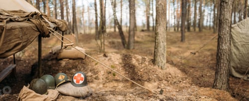 Preview: Metal Helmets Of United States Army Infantry Soldier At World War II. Helmets Near Camping Tent In