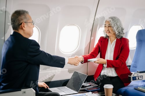 Preview: Business meeting in airplane, asian Mature businessman in private jet is talking with Mature female