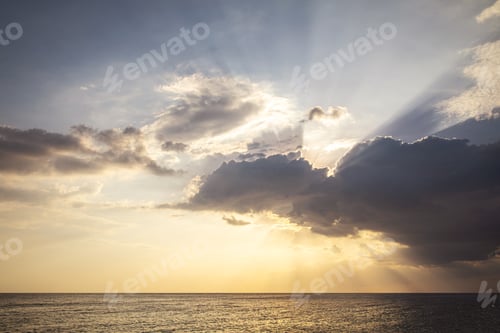Preview: Sunbeams Breaking Through Clouds Over Sea