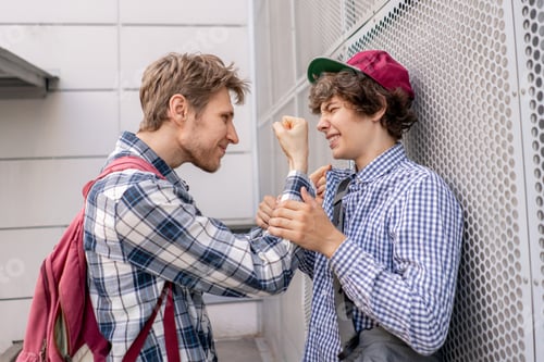 Preview: two guys fight each other, one adult threaten to the student, push against the wall, bully concepts