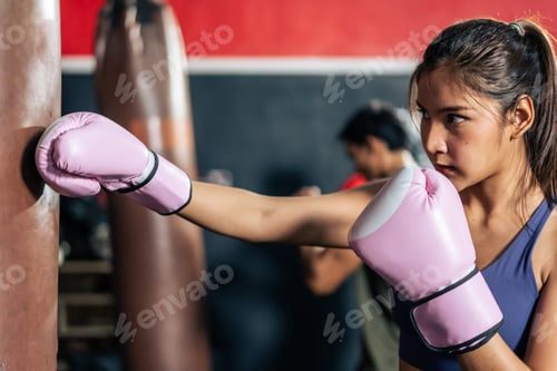 Preview: Asian active female sportswoman wearing sport clothes and boxing glove.