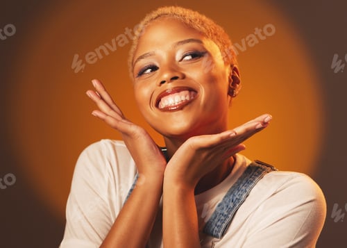 Preview: Playful, happy and beautiful black woman with hands isolated on a brown studio background. Crazy, f