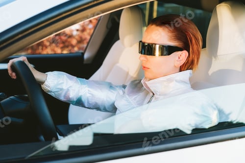 Preview: Fashion cyberpunk girl drive a supercar. woman with futuristic eyeglasses sits by the car wheel.
