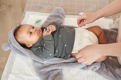 Mother Changing Babys Diaper Close Up