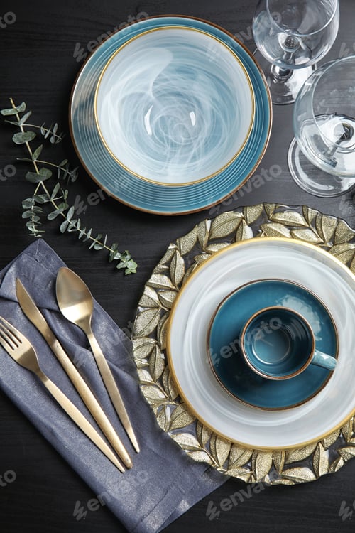 Preview: Elegant table setting on dark background, top view
