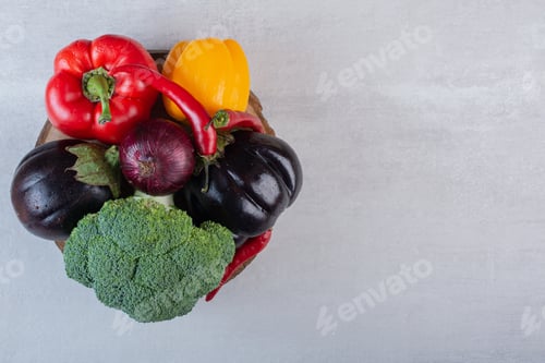 Preview: Broccoli, eggplants and peppers on wooden piece