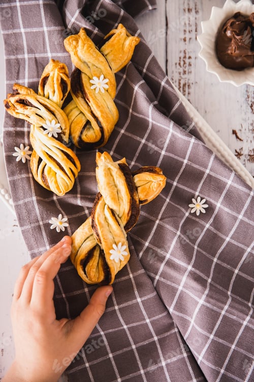 Preview: Kids hand taking delicious Palmiers with chocolate on wooden background