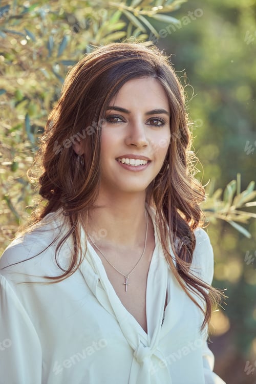 Preview: Attractive woman standing in nature