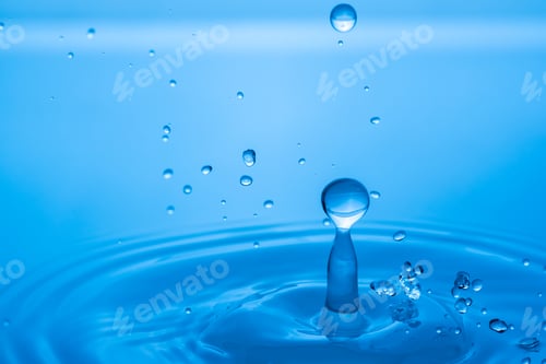 Preview: Water drop splashing into blue water surface