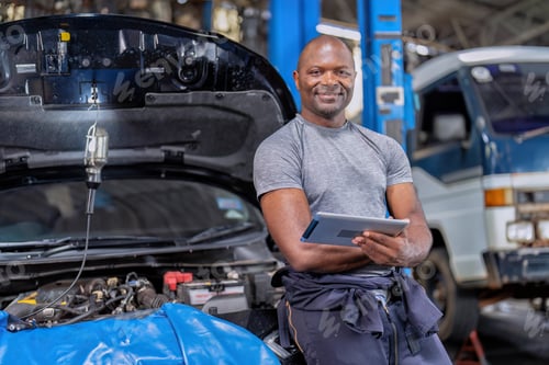 Preview: Mechanical guy at car repair shop stand smiling to camera portrait