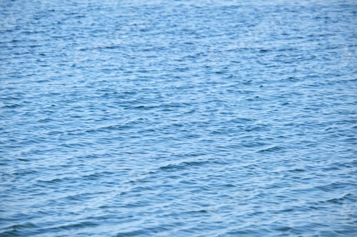Preview: Closeup seascape surface of blue sea water with small ripple waves.