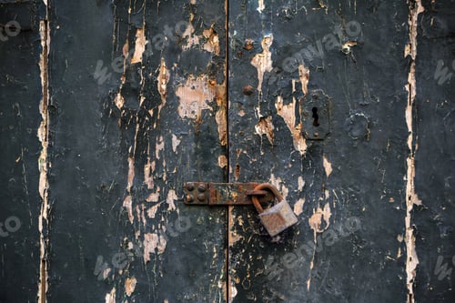 Preview: Wooden dark grey door background locked with rusty padlock.