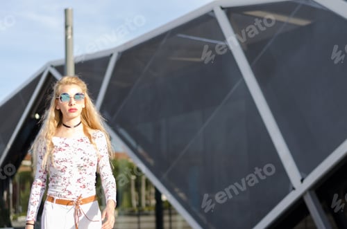 Preview: fashion young woman businesswoman walking with sunglasses on the street