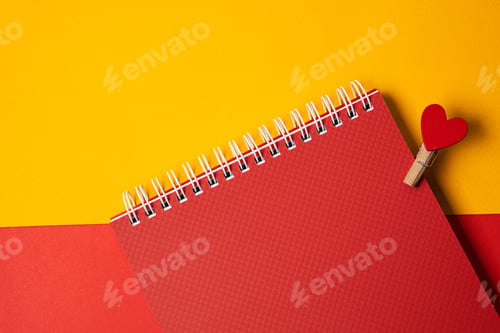 Preview: Spring notepad and wooden clothespin with red heart cropped view of office supplies