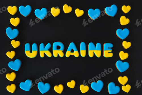 Preview: The word Ukraine on a black background, made with handmade gingerbread.