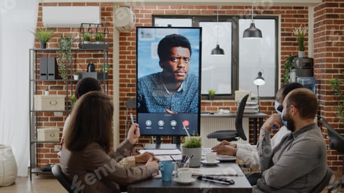 Preview: Business people using remote video call chat on monitor