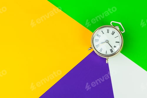 Preview: Black alarm clock on color block background, office interior