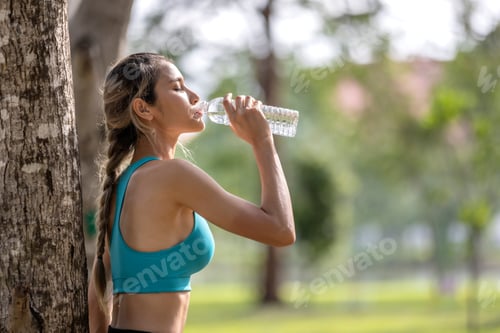 Preview: Woman Drinks Water After Workout in Park