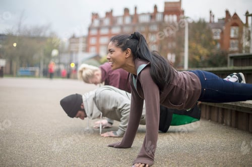 Preview: Group of adults exercising in urban environment