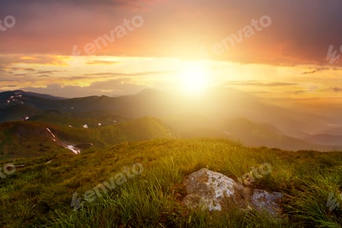 Preview: Sunset landscape with green grass meadow, high peaks