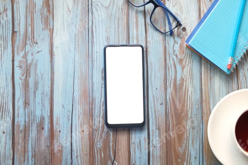 Preview: top view of smart phone and notepad on table