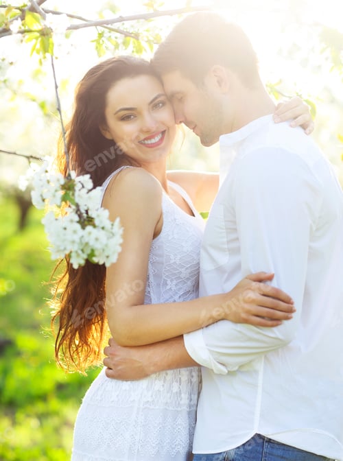 Preview: Couple in love kissing and hugging in spring park