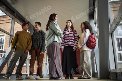 Preview: Multiethnic Group of University Students Socializing in Modern Campus Hallway