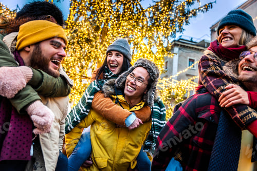 Preview: Happy friends having fun enjoying Christmas day in city street