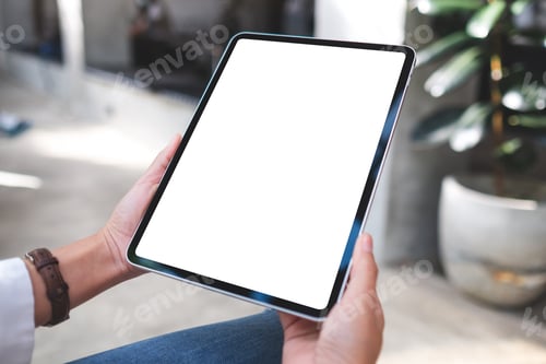 Preview: Mockup image of a woman holding digital tablet with blank white desktop screen in cafe