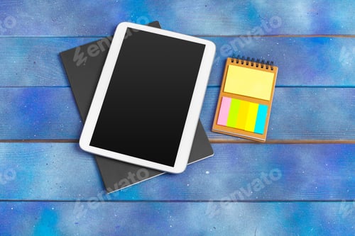 Preview: Workplace with blank digital tablet, paper on blue wooden work table. Above view shot