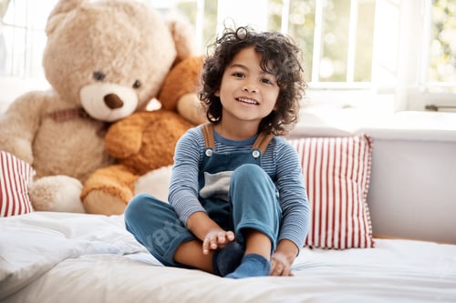 Preview: Portrait of an adorable young boy relaxing in his bedroom at home
