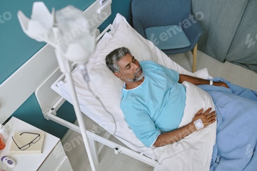 Preview: Middle Aged Biracial Man Resting in Hospital Bed during Medical Recovery