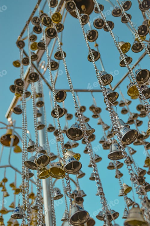 Preview: Low angle view of silver and golden bells during the Songkran Festival in Thailand