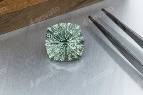 Preview: macro mineral faceted stone cut Beryl on a gray background