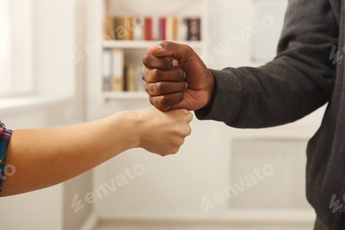 Preview: Black Man And Caucasian Woman Touching Knuckles, Closeup. Agreement, Partnership, Power, Teamwork