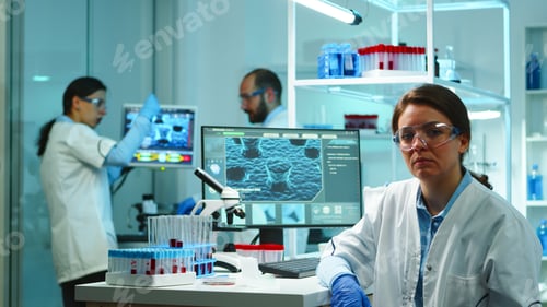 Preview: Portrait of scientist nurse looking exhausted at camera