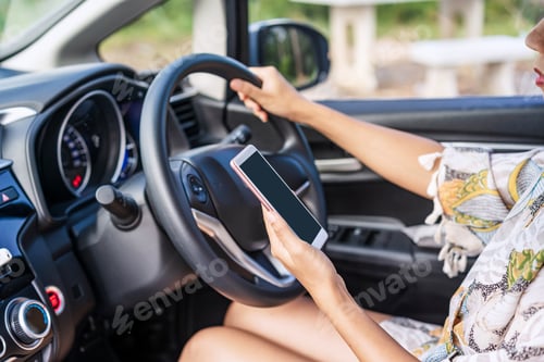 Preview: Young female driver using a phone while driving, indicating negligence