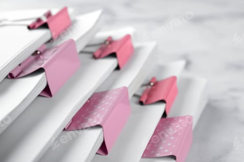 Preview: Stack of documents with binder clips on marble table, closeup