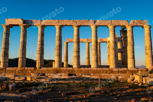 Preview: sunshine on ancient columns of parthenon in athens against blue sky