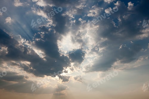 Preview: Sunbeams breaking through a dramatic cloudy sky.