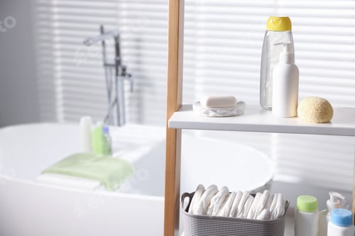 Preview: Baby bathing products and diapers on rack in bathroom, closeup