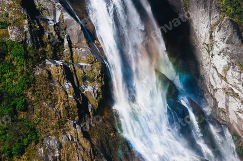 Preview: Rainbow in waterfall over cliffs