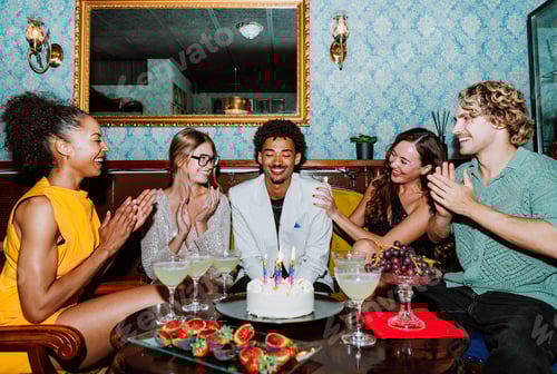 Preview: Diverse friends celebrating birthday party with cake and cocktails