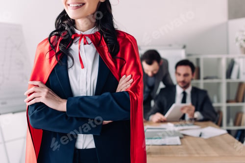 Preview: cropped image of super businesswoman in cape standing with crossed arms