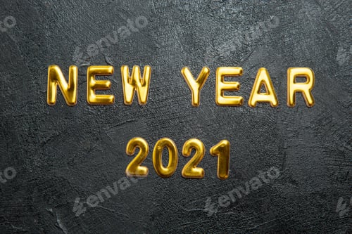 Preview: Top view of greeting golden text New Year and on dark background