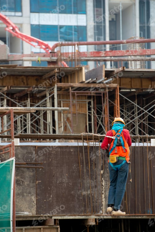 Preview: Construction workers fabricating steel reinforcement bar at the construction site