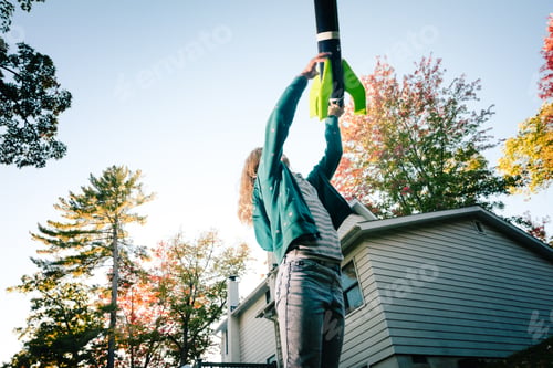 Preview: Girl throwing toy rocket upward toward blue sky