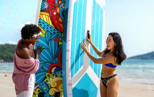 Preview: Active summer lifestyle with beach sports, fitness romance. Happy couple enjoying paddle boarding