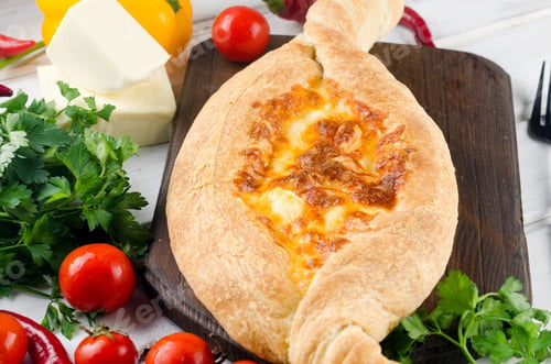 Preview: Khachapuri with cheese closeup. Adjarian open pie with mozzarella.