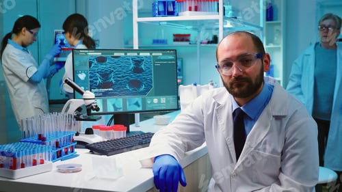 Preview: Exhausted portrait of chemist doctor looking up at video camera
